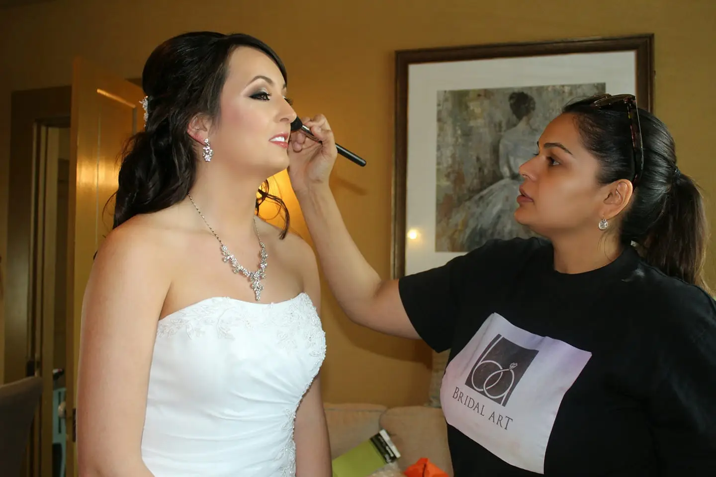 Asra doing a bride's makeup on location at her hotel, Houston